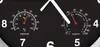 A close-up of a black wall clock with two gauges: a thermometer and a hygrometer. The clock face has large numbers and hands. Produktbild-Vorschau