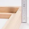 A close-up view of a wooden frame corner with a ruler measuring its thickness. Náhľad obrázku produktu