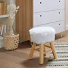 A fluffy white stool sits on a wooden floor next to a dresser and a bookshelf with dried flowers in a vase. Podgląd zdjęcia produktu