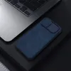 A dark, moody product shot featuring a blue phone case next to a laptop. Podgląd zdjęcia produktu