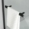 A close-up view of a black towel rack attached to a wall with a white towel hanging on it. Podgląd zdjęcia produktu