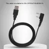 A black USB programming cable with a USB-A connector on one end and a 3.5mm dual-pin connector on the other, coiled on a white surface against a gradient background. Náhled obrázku produktu