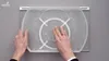 Hands interacting with a clear plastic turntable for a refrigerator. Anteprima dell’immagine prodotto
