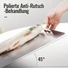A hand is shown holding a metal cutting board with a fish on it, demonstrating its anti-slip feature. Produktbild-Vorschau
