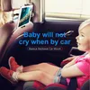 A child is sitting in a car seat, looking at a tablet mounted on the back of the front seat. Voir les images du produit
