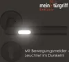 A dark image featuring a door handle with a glowing light and text. Produktbild-Vorschau