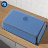 A kitchen sink with a blue overlay, placed on a wooden countertop with a tiled backsplash. Produktbild-Vorschau