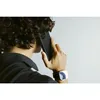 A person is holding a smartphone to their ear, wearing a watch. Anteprima dell’immagine prodotto