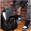A person is packing a music production controller into a backpack. Anteprima dell’immagine prodotto
