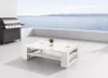 A white wooden coffee table with two cups and a small plant on a patio overlooking the ocean, with a grill to the left. Produktbild-Vorschau