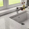 A close-up view of a kitchen sink and faucet with a window in the background. Produktbild-Vorschau