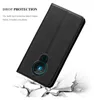 A black phone case is shown in a dynamic pose, appearing to be dropped onto a cracked surface, illustrating its protective qualities. Náhled obrázku produktu