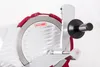 A close-up view of a red and silver meat slicer. Náhled obrázku produktu