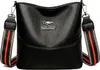A black leather handbag with a decorative strap. Náhľad obrázku produktu