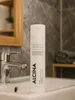 A bottle of shampoo is placed on a sink in a bathroom. Produktbild-Vorschau