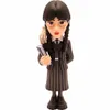 A figurine of Wednesday Addams holding a book, with Thing's hand on her shoulder. Podgląd zdjęcia produktu