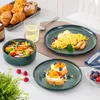 A table setting with various dishes, including salad, pasta, and toast with fruit, suggesting a meal or a spread of food. Náhled obrázku produktu