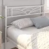 A white metal bed frame with a decorative headboard is shown with pillows and bedding. Produktbild-Vorschau
