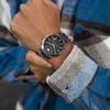 A person wearing a plaid shirt and a silver Emporio Armani watch. Náhľad obrázku produktu