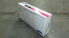 A cardboard box for a Samsung toner cartridge is placed on a concrete floor. Produktbild-Vorschau
