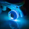 A close-up shot of a roller skate wheel with colorful LED lights, reflecting on a dark surface. Náhled obrázku produktu