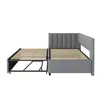A grey upholstered bed frame with an extended wooden slat base, shown from the side against a white background. Anteprima dell’immagine prodotto