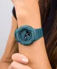 A close-up shot of a person's arm wearing a teal G-Shock watch. Produktbild-Vorschau