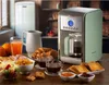 A breakfast spread with a coffee maker, croissants, fruit, juice, and toast. Podgląd zdjęcia produktu