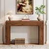 A wooden console table with decorative items on top and a basket underneath, placed in a well-lit room. Anteprima dell’immagine prodotto