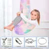 A young girl is sitting in a colorful sensory swing, with product accessories shown below. Produktbild-Vorschau