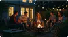A group of friends enjoying a bonfire in a backyard at night, roasting marshmallows and playing guitar. Anteprima dell’immagine prodotto