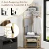 A corner garment rack with clothes and folded items, with an inset showing an anti-tipping kit. Podgląd zdjęcia produktu