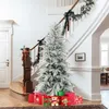 A Christmas tree decorated with snow and surrounded by gifts in a home entryway. Podgląd zdjęcia produktu