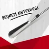 A close-up of a shoehorn with text overlay on a wooden background. Produktbild-Vorschau