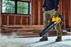 A person is using a DeWALT leaf blower to clear debris from a concrete floor inside a building under construction. Anteprima dell’immagine prodotto