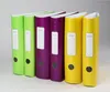 A row of six colorful binders on a plain background. Voir les images du produit