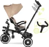 A studio shot of a beige and black children's tricycle with a canopy and parent handle. Produktbild-Vorschau
