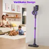 A woman and child are playing with a dog on the floor in a living room, while a purple cordless vacuum cleaner is mounted on the wall. Produktbild-Vorschau