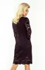 A woman wearing a black lace dress, shown from the back and side. Náhled obrázku produktu