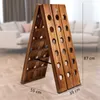A wooden wine rack is shown in a living room setting. Produktbild-Vorschau