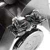 A close-up view of a metal sculpture of a wedding couple on a tractor, decorated with flowers. Produktbild-Vorschau