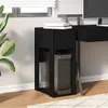A black computer cabinet with a drawer is placed next to a desk, with a plant on the left and a window with blinds in the background. Podgląd zdjęcia produktu