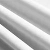 Close-up view of white fabric with a subtle striped pattern, folded into soft waves. Produktbild-Vorschau