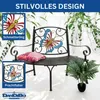 A metal garden bench with butterfly decorations, placed outdoors with plants. Anteprima dell’immagine prodotto