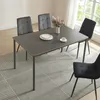 A dining table with chairs set up in a room with natural light from a window. Anteprima dell’immagine prodotto