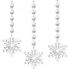 Three clear acrylic snowflake ornaments hang from chains of faceted beads against a white background. Produktbild-Vorschau