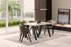 A modern dining room with a table and chairs set up, featuring a fireplace and artwork in the background. Produktbild-Vorschau