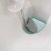 A toilet brush and its holder are shown inside a toilet bowl. Náhled obrázku produktu