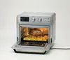 A silver air fryer oven with a rotisserie chicken and potatoes inside, shown with the door open. Podgląd zdjęcia produktu