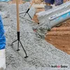 Construction workers pouring and spreading concrete. Produktbild-Vorschau